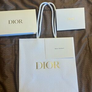 Dior bag and card says merry Christmas on it